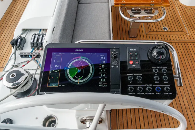 Slide: The Image of Beneteau Oceanis Yacht 54 cockpit with navigation controls and teak flooring, 2022 model. - 63