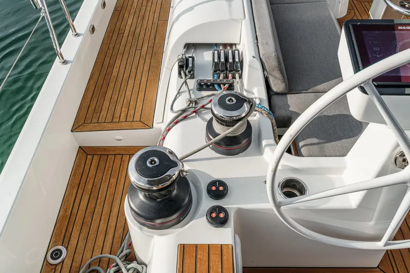 Slide: The Image of Cockpit of 2022 Beneteau Oceanis Yacht 54 with teak decking and modern sailing equipment. - 64
