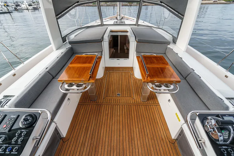 Slide: The Image of Luxurious 2022 Beneteau Oceanis Yacht 54 cockpit with teak flooring and elegant seating. - 70