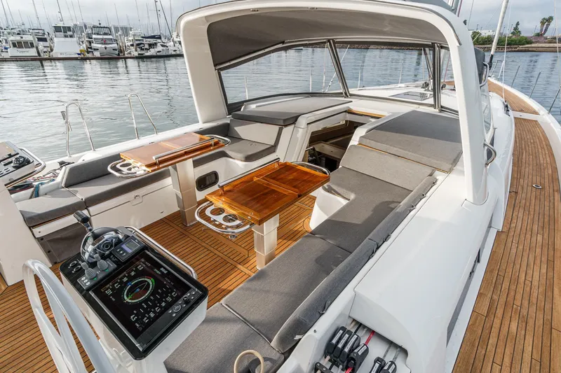 Slide: The Image of Luxurious 2022 Beneteau Oceanis Yacht 54 cockpit with teak deck and modern navigation controls. - 72