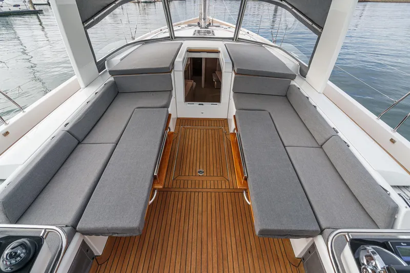 Slide: The Image of Luxurious 2022 Beneteau Oceanis Yacht 54 cockpit with sleek seating and teak flooring. - 73