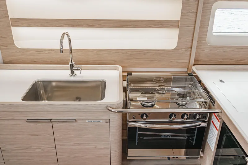 Slide: The Image of Modern kitchen in 2022 Beneteau Oceanis Yacht 54 with sink and stove. - 8