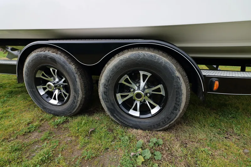 Slide: The Image of 2018 Regal 26 Express trailer wheels on grass. - 10