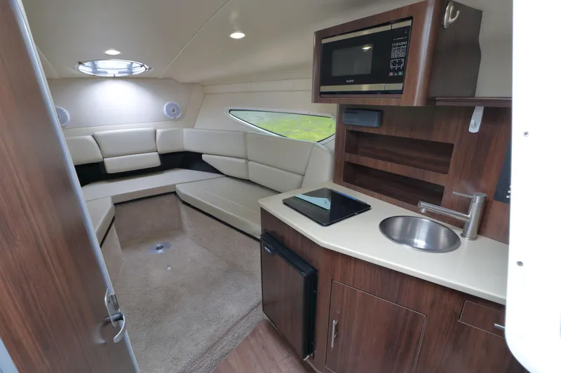 Slide: The Image of Interior of 2018 Regal 26 Express with kitchenette and seating area. - 16