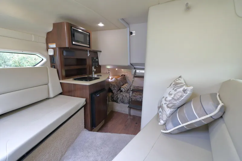 Slide: The Image of Interior of 2018 Regal 26 Express with kitchen and seating area. - 17