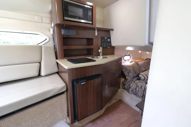 Slide: The Image of Interior of 2018 Regal 26 Express with kitchenette and sleeping area. - 19