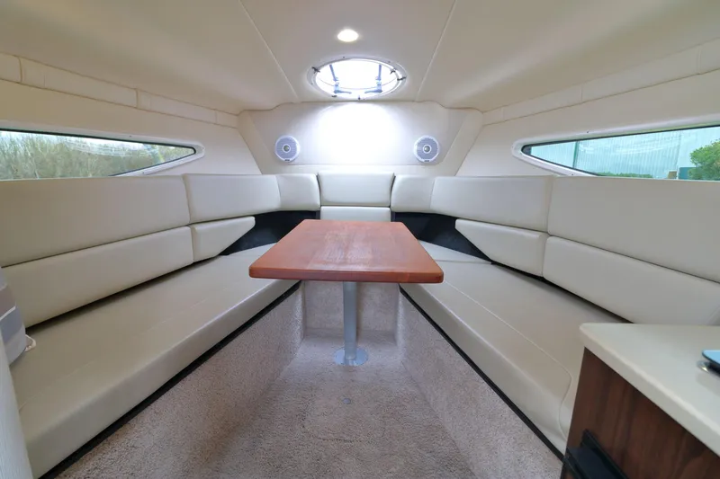 Slide: The Image of Interior of a 2018 Regal 26 Express yacht with table and seating area. - 21