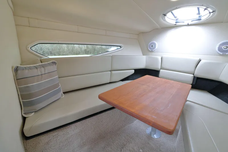 Slide: The Image of Interior of a 2018 Regal 26 Express with seating area and table. - 23