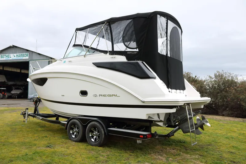 Slide: The Image of 2018 Regal 26 Express boat on trailer outdoors. - 3