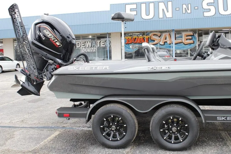 Slide: The Image of 2026 Skeeter ZXE21 boat with Yamaha engine, displayed at a boat sale event. - 2