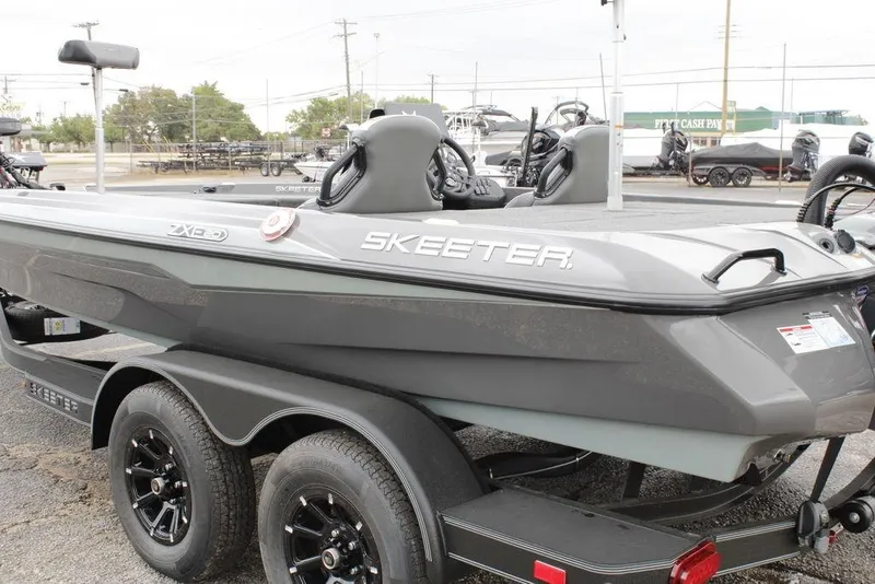 Slide: The Image of 2026 Skeeter ZXE21 boat on trailer, gray color, parked outdoors. - 7