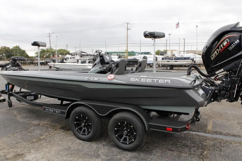 Slide: The Image of 2026 Skeeter ZXE21 fishing boat with Yamaha motor on trailer in parking lot. - 8