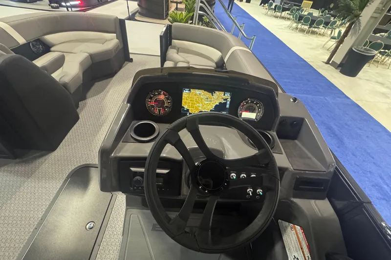 Slide: The Image of Steering console of 2026 Evotti 521QL boat with navigation display and seating area. - 7