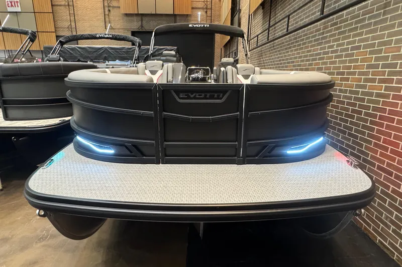 Slide: The Image of 2026 Evotti 725QL pontoon boat with sleek design and LED lights in showroom. - 1