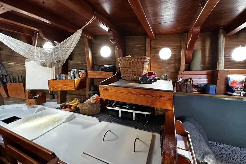 Slide: The Image of Interior of a 2005 custom sail-assisted trawler with wooden furnishings and nautical decor. - 12
