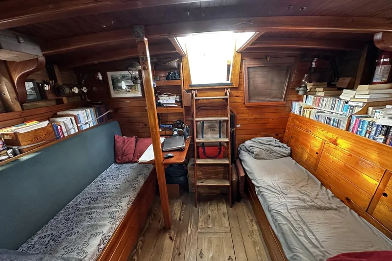 Slide: The Image of Cozy cabin interior of 2005 custom sail-assisted trawler with wooden decor and bookshelves. - 14