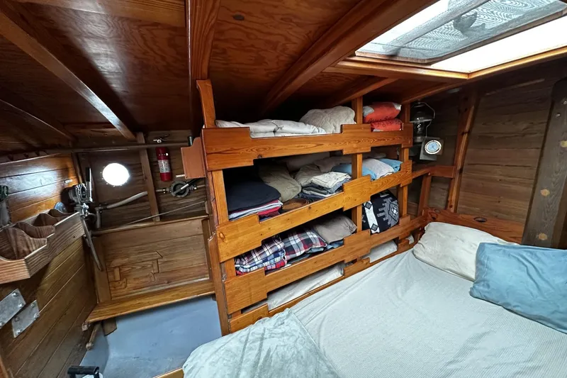 Slide: The Image of Cozy cabin interior of 2005 custom sail-assisted trawler with wooden shelves and bedding. - 21