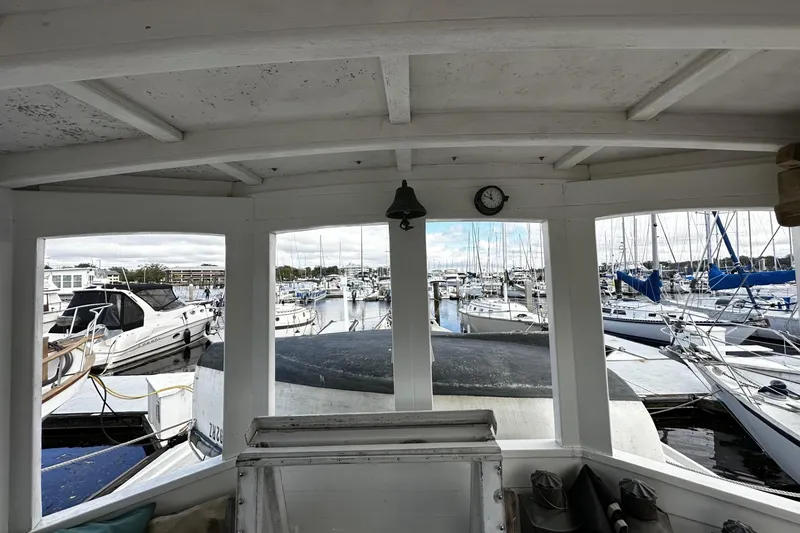 Slide: The Image of View from a 2005 Custom Sail-Assisted Trawler overlooking a marina with various boats. - 25