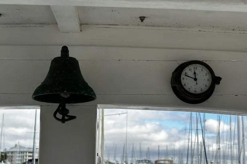 Slide: The Image of Bell and clock on 2005 custom sail-assisted trawler, marina background. - 26