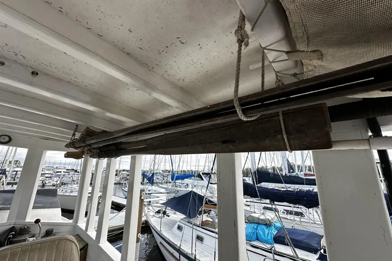 Slide: The Image of Interior view of a 2005 Custom Sail-Assisted Trawler docked at a marina. - 30