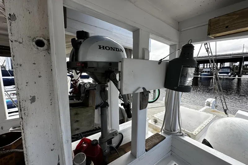 Slide: The Image of Honda motor on 2005 Custom Sail-Assisted Trawler, docked near marina with bridge view. - 31