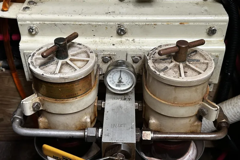 Slide: The Image of Dual fuel filters with pressure gauge on 2005 Custom Sail-Assisted Trawler engine. - 48