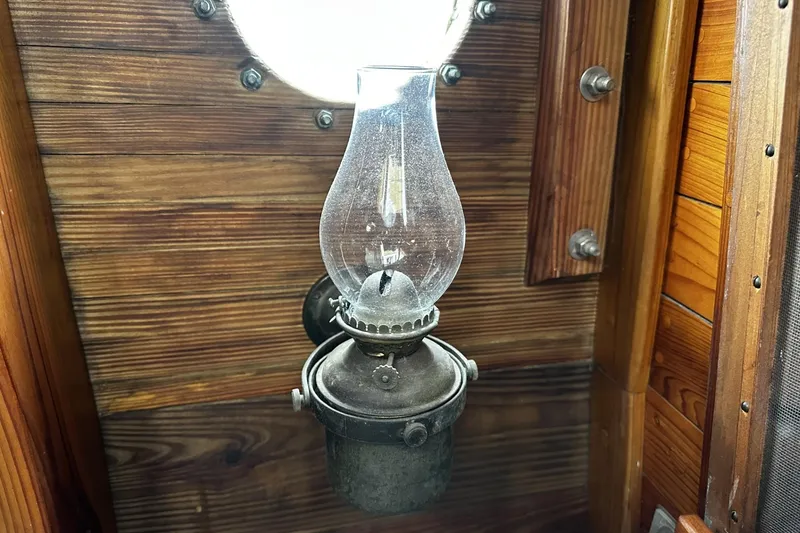 Slide: The Image of Vintage oil lamp on wooden wall of 2005 Custom Sail-Assisted Trawler interior. - 53
