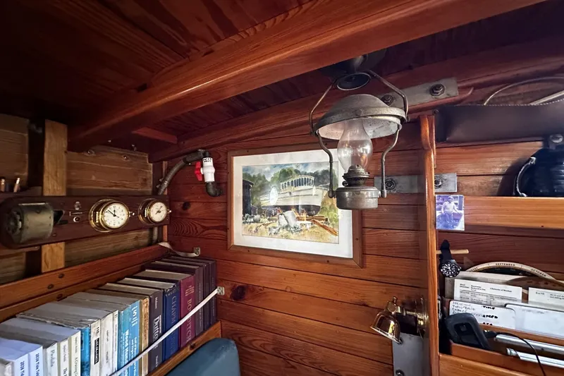 Slide: The Image of Cozy wooden cabin interior of 2005 Custom Sail-Assisted Trawler with nautical decor and books. - 55