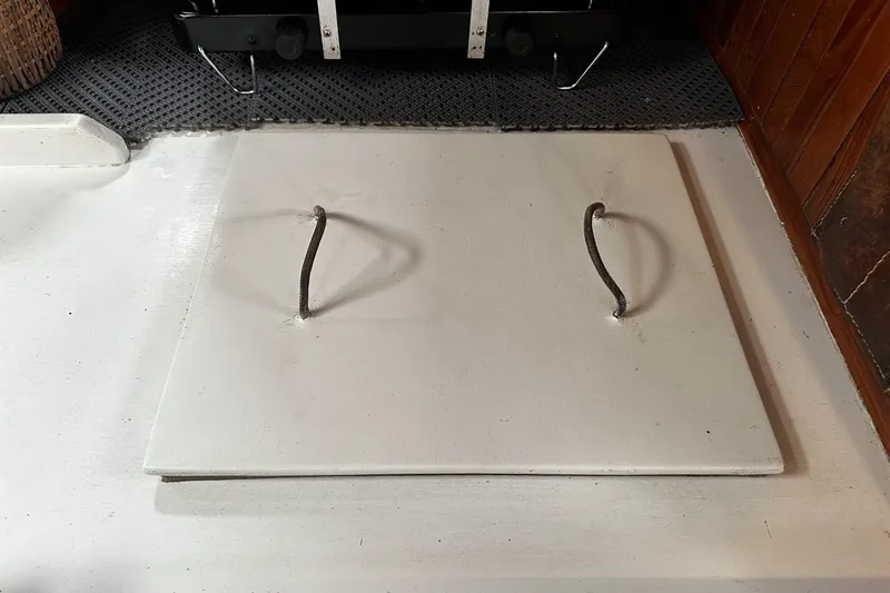 Slide: The Image of Hatch cover on 2005 Custom Sail-Assisted Trawler, featuring two metal handles. - 59