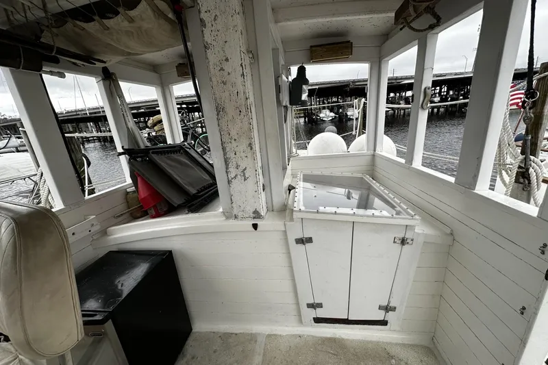 Slide: The Image of Interior of a 2005 custom sail-assisted trawler with dockside view. - 6