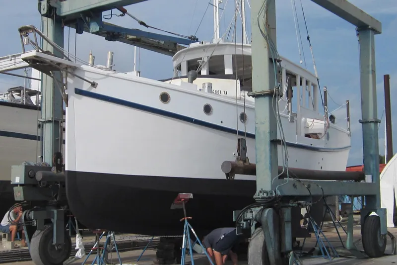 Slide: The Image of Custom 2005 sail-assisted trawler in dry dock, undergoing maintenance and inspection. - 64