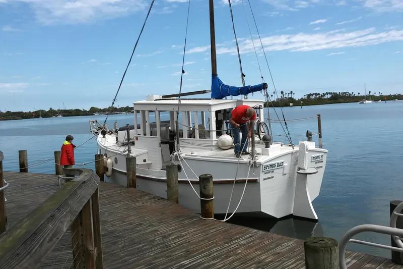 Slide: The Image of Custom 2005 sail-assisted trawler docked at a wooden pier on a sunny day. - 67