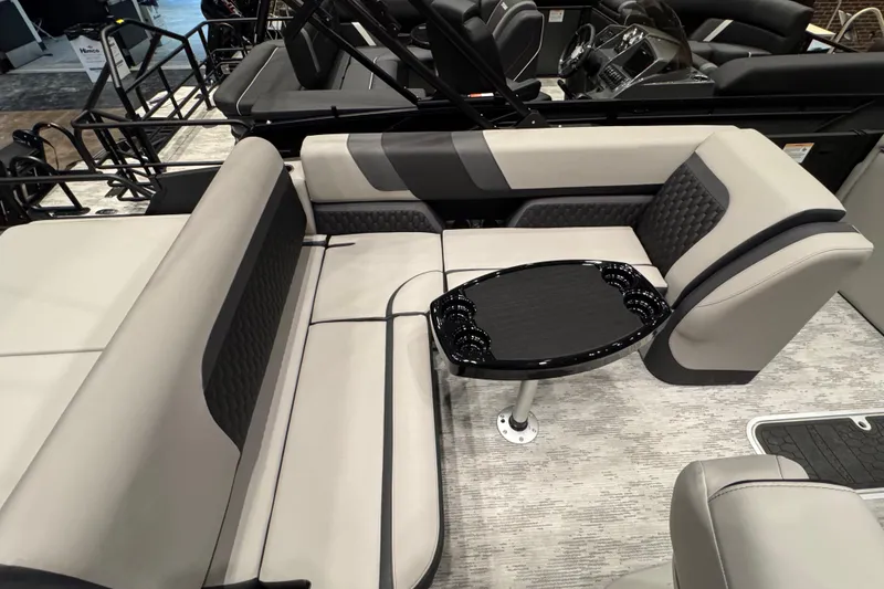Slide: The Image of 2026 Sylvan L3 DLZ Bar pontoon boat interior with sleek seating and table. - 7