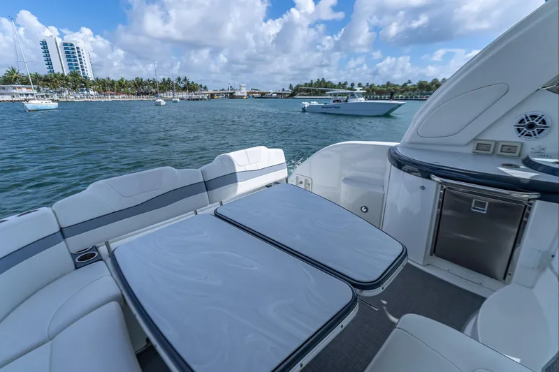 Slide: The Image of 2022 Formula 40 Performance Cruiser, luxurious deck view, docked near palm-lined shore. - 28