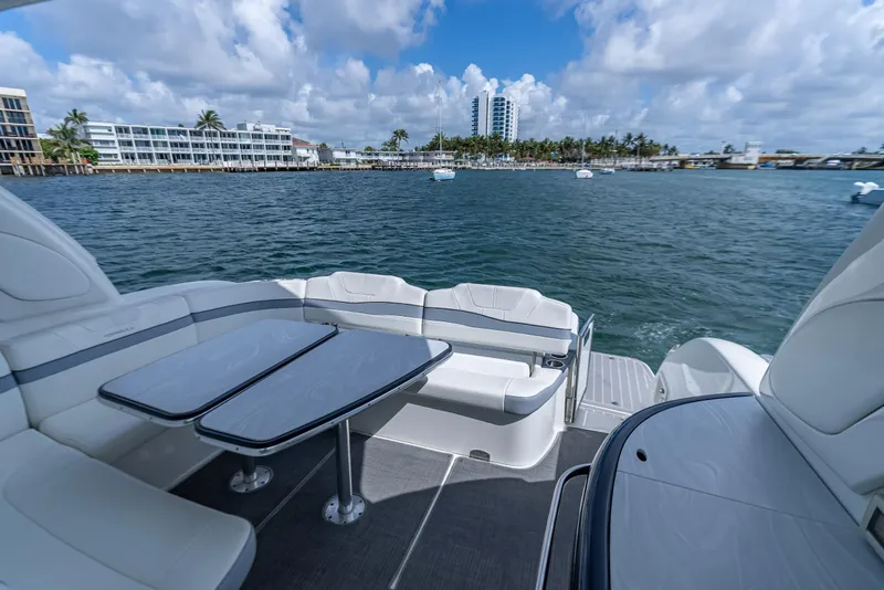 Slide: The Image of 2022 Formula 40 Performance Cruiser deck with seating and tables, overlooking a scenic waterfront. - 29