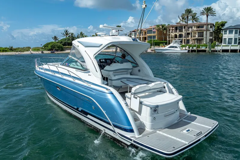 Slide: The Image of 2022 Formula 40 Performance Cruiser on water near luxury waterfront homes. - 3
