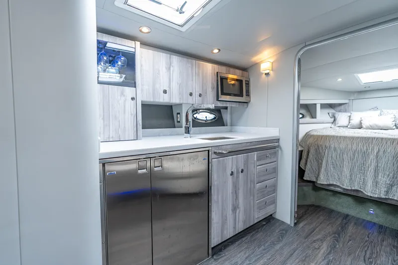 Slide: The Image of 2022 Formula 40 Performance Cruiser interior with modern kitchen and cozy bedroom. - 39