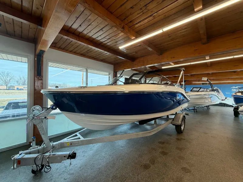 The Image of 2026 Bayliner V20 boat in showroom on trailer. - 0