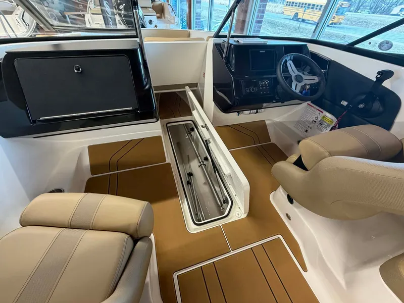 Slide: The Image of Interior of 2026 Bayliner V20 with modern seating and control console. - 15
