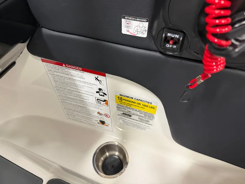 Slide: The Image of Bayliner V20 2026 boat control area with safety and capacity notices. - 13