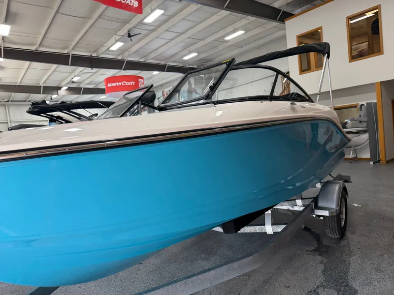 Slide: The Image of 2026 Bayliner V20 boat displayed in a showroom. - 2