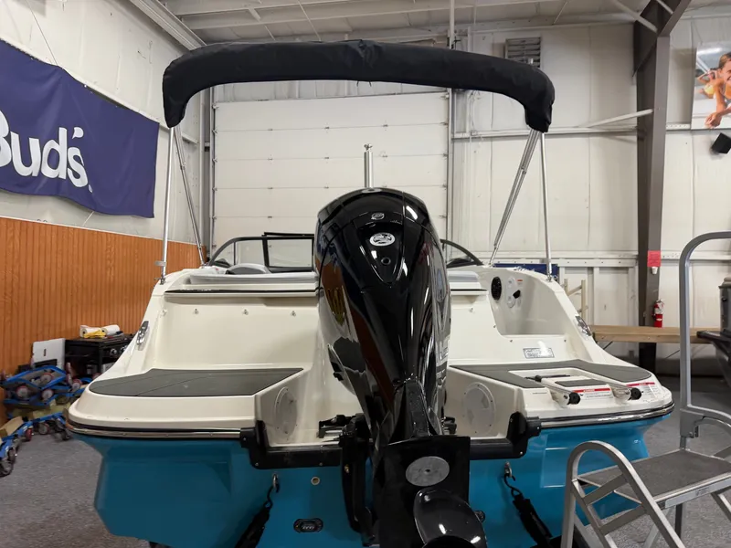Slide: The Image of 2026 Bayliner V20 boat in showroom with outboard motor. - 3