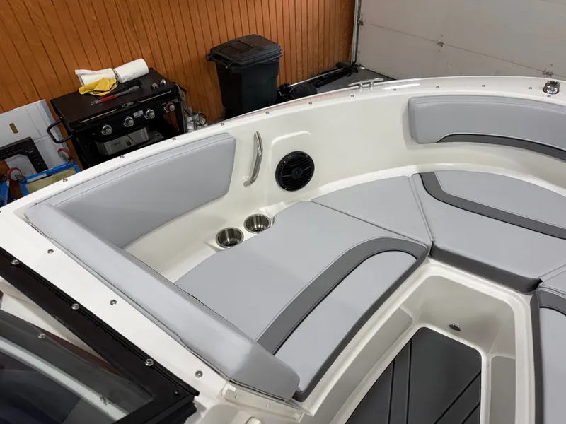 Slide: The Image of Interior of 2026 Bayliner V20 with gray cushions and cup holders. - 8