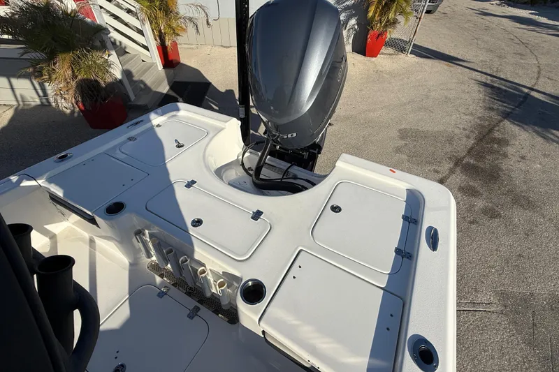 Slide: The Image of 2025 Sea Pro 230 Bay boat with outboard motor and storage compartments. - 11