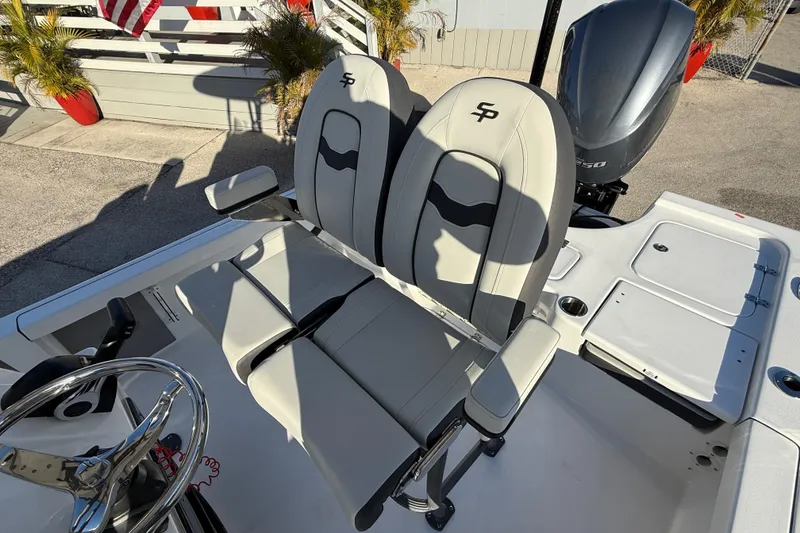 Slide: The Image of 2025 Sea Pro 230 Bay boat interior with dual seats and steering wheel. - 12