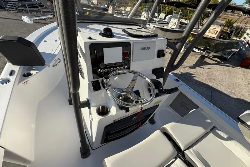 Slide: The Image of 2025 Sea Pro 230 Bay boat console with steering wheel and Simrad electronics. - 13