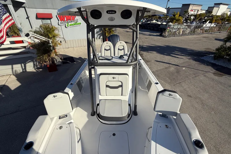 Slide: The Image of 2025 Sea Pro 230 Bay boat, white interior, outdoor display, dealership setting. - 15