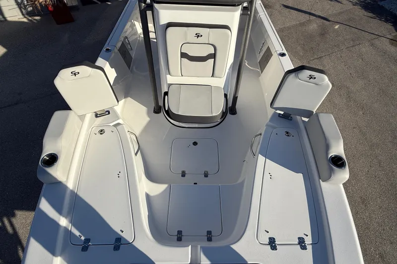 Slide: The Image of 2025 Sea Pro 230 Bay boat interior with seating and storage compartments. - 16