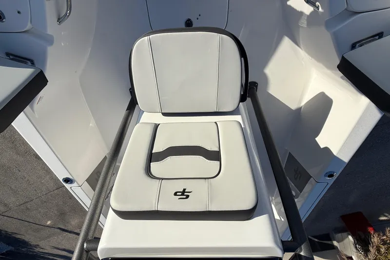 Slide: The Image of 2025 Sea Pro 230 Bay boat seat with white and black cushioned design. - 17