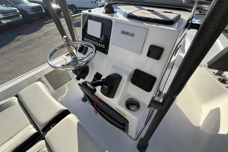 Slide: The Image of 2025 Sea Pro 230 Bay boat console with steering wheel and Simrad display. - 20